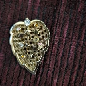 Leaf with gems can be worn as a brooch or necklace charm